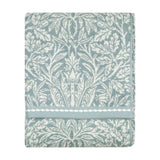 Folded Acorn Jacquard Cotton Towel in mineral blue with cream acorn and foliage design, woven border detail, shown against a plain white background.