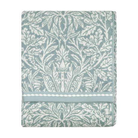 Folded Acorn Jacquard Cotton Towel in mineral blue with cream acorn and foliage design, woven border detail, shown against a plain white background.