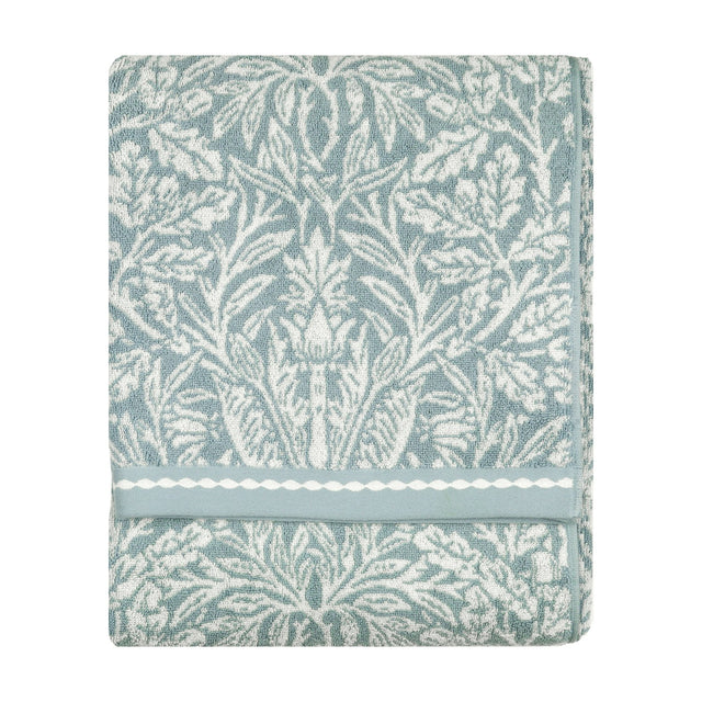 Folded Acorn Jacquard Cotton Towel in mineral blue with cream acorn and foliage design, woven border detail, shown against a plain white background.