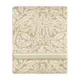 Folded Acorn Jacquard cotton towel in natural beige and cream, featuring a woven acorn and oak-leaf pattern with a scalloped braid border, shown on a plain white background.