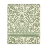 Folded cotton towel with sage green acorn and foliage jacquard pattern on cream, banded trim edge, shown on a plain white background.