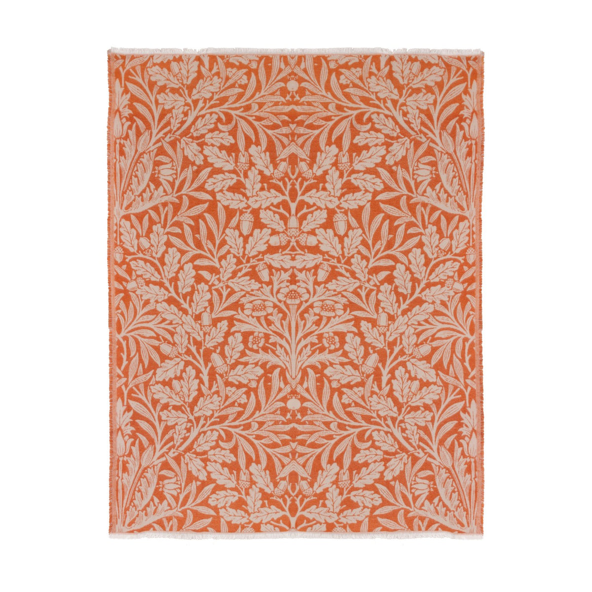 Acorn Tonal Jacquard Cotton Blend Throw in brick orange, woven with a cream botanical pattern of oak leaves and acorns, shown with fringed edges on a plain white background.