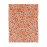 Acorn Tonal Jacquard Cotton Blend Throw in brick orange, woven with a cream botanical pattern of oak leaves and acorns, shown with fringed edges on a plain white background.