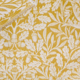 Acorn Tonal Jacquard Cotton Blend Throw in gold and cream, woven with an Acorn oak leaf and acorn pattern and finished with a short fringed edge.