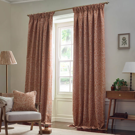 Acorn Tonal Jacquard pencil pleat curtains in brick with a paler acorn branch pattern, shown floor-length beside a window in a living room setting.
