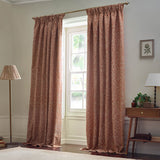Acorn Tonal Jacquard pencil pleat curtains in brick with a paler acorn branch pattern, pencil pleat heading on a brass pole in a living room window setting.