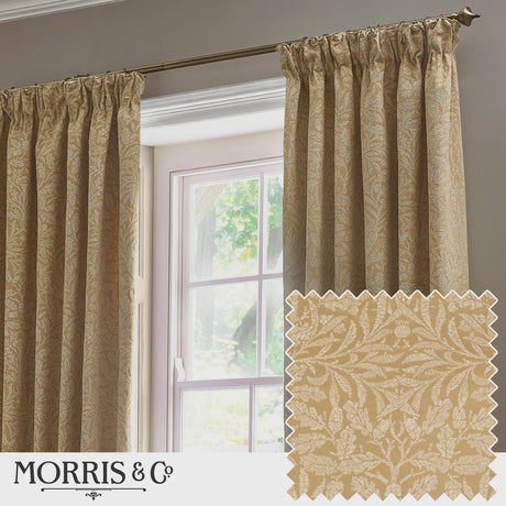 Saffron-gold pencil pleat curtains in Acorn tonal jacquard hang from a bronze pole beside a window, with a matching fabric swatch shown in the corner.