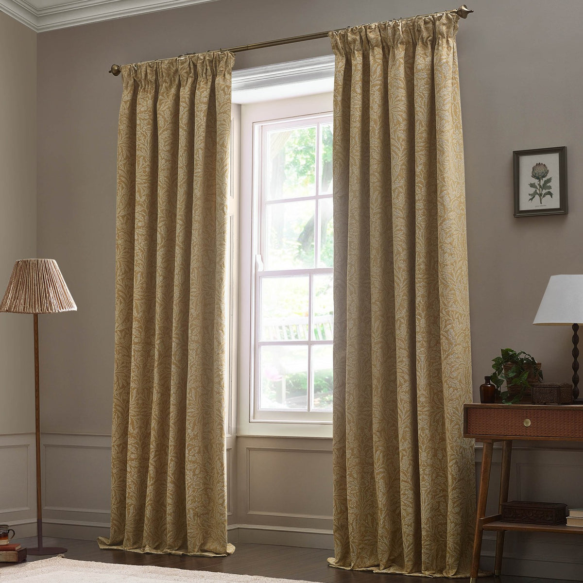 Saffron-gold pencil pleat curtains in Acorn tonal jacquard fabric, hung from a bronze pole beside a window in a living room setting.