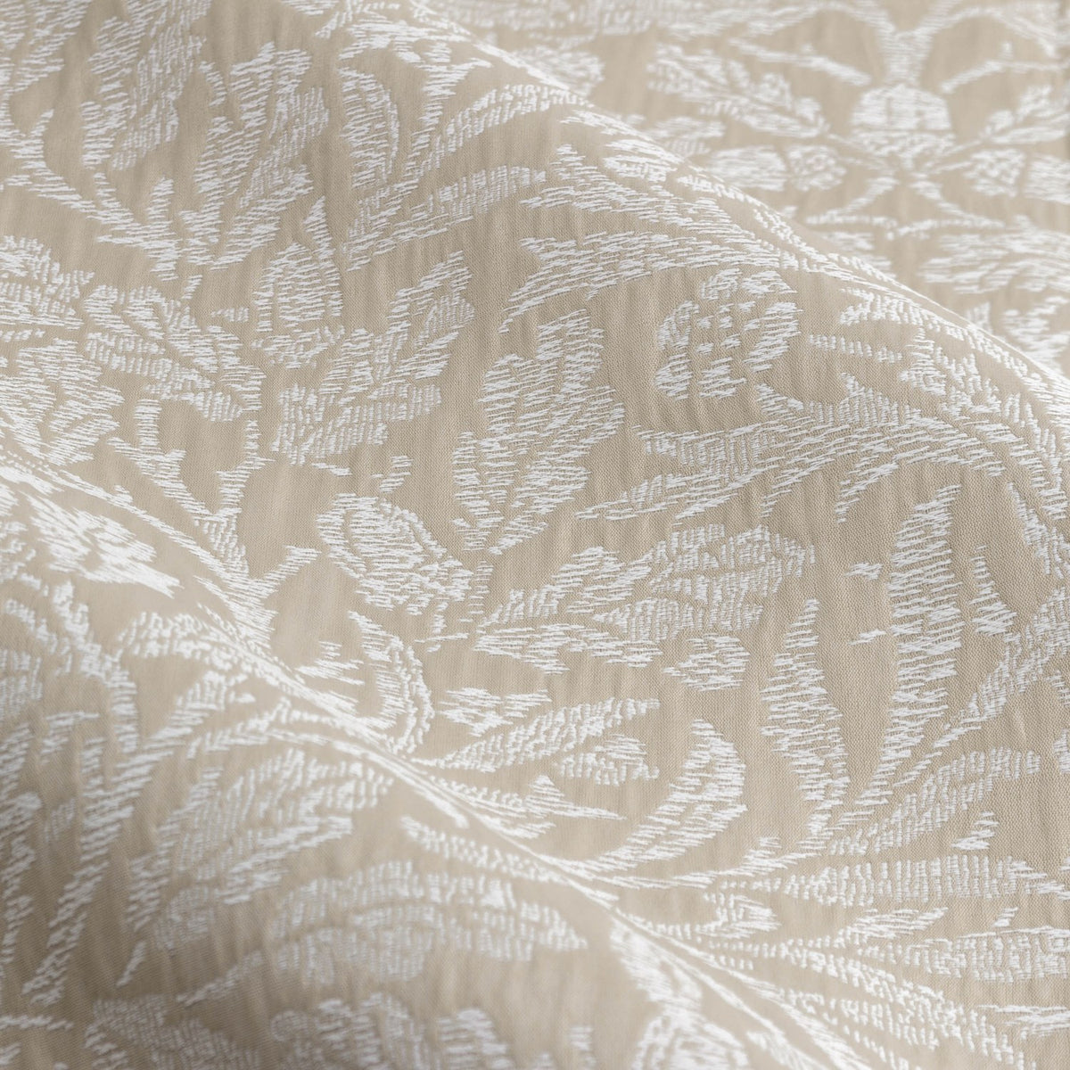 Close-up of Acorn Tonal Jacquard pencil pleat curtain fabric in linen beige, showing woven acorn and oak leaf pattern in matt white-toned jacquard.