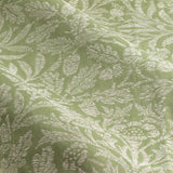 Close-up of Acorn Tonal Jacquard pencil pleat curtain fabric, showing woven oak leaf and acorn motifs in cream against a sage green polyester ground.