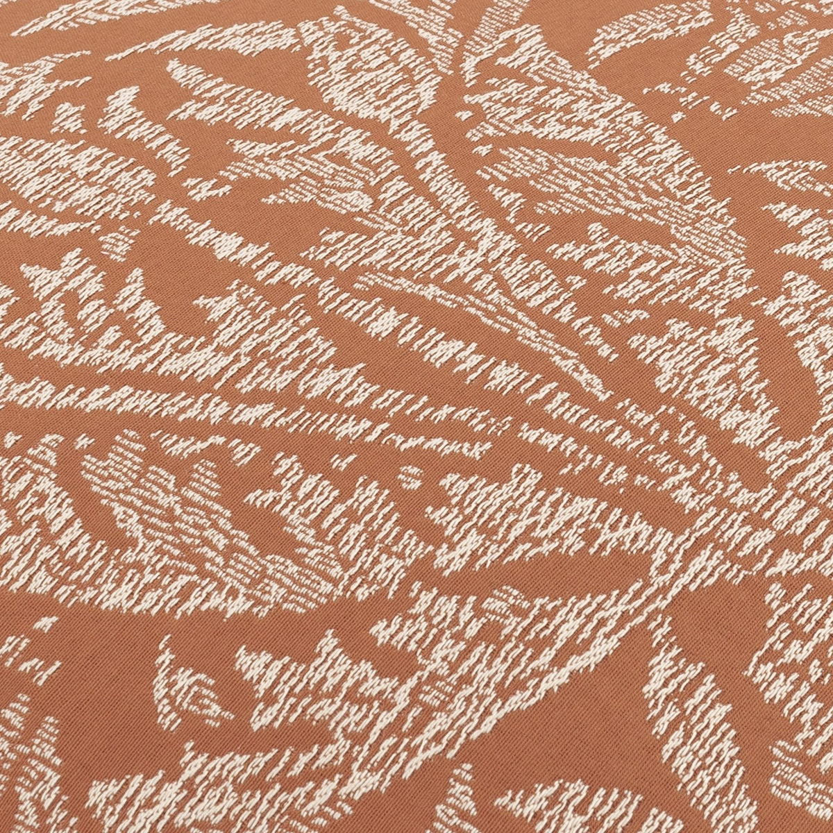 Close-up of the Acorn Tonal Jacquard Polyester Cushion in Brick, showing a woven cream oak leaf and acorn pattern on a textured brick-orange ground.