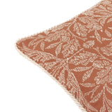 Acorn Tonal Jacquard Polyester Cushion in brick orange, close-up of the corner showing the woven cream oak leaf and acorn pattern with a matching cream twisted cord edge trim.