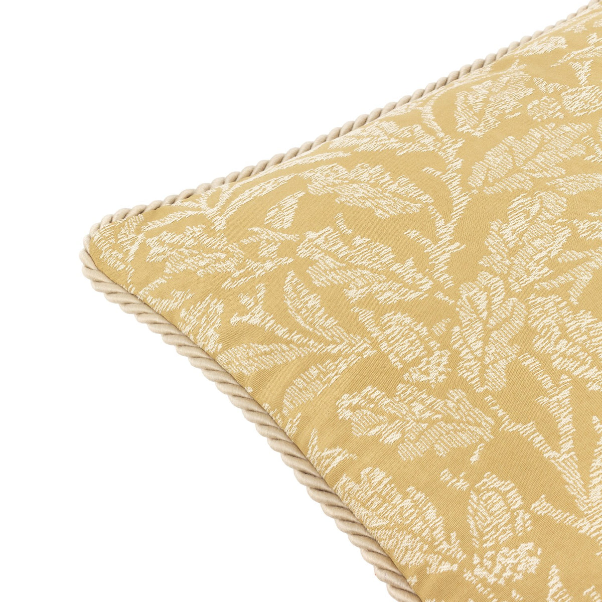 Close-up corner view of the Acorn Tonal Jacquard Polyester Cushion in gold, showing woven cream acorn and foliage motifs with a twisted cord edge trim, on a plain white background.