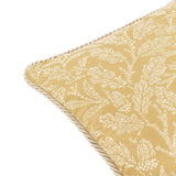 Close-up corner view of the Acorn Tonal Jacquard Polyester Cushion in gold, showing woven cream acorn and foliage motifs with a twisted cord edge trim, on a plain white background.