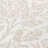Close-up of the Acorn Tonal Jacquard Polyester Cushion in ivory, showing a mirrored acorn branch pattern woven in tonal beige on textured fabric.