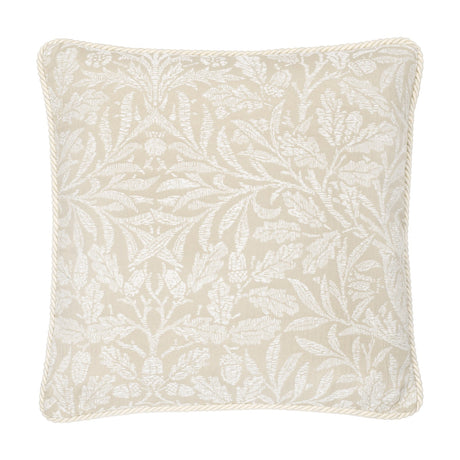 Square cushion in Acorn tonal jacquard, showing white branching leaf and acorn motifs on a natural linen-toned ground with cream cord piping, on a white background.