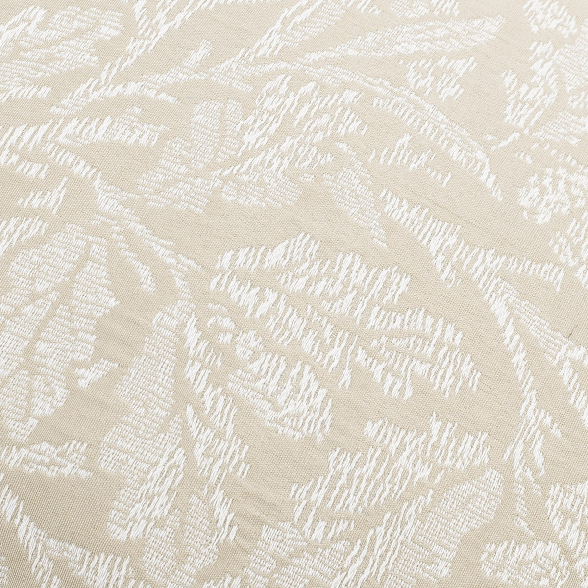 Close-up of the Acorn Tonal Jacquard Linen Cushion showing a white woven branch, leaf and acorn pattern on a soft linen-toned fabric ground.