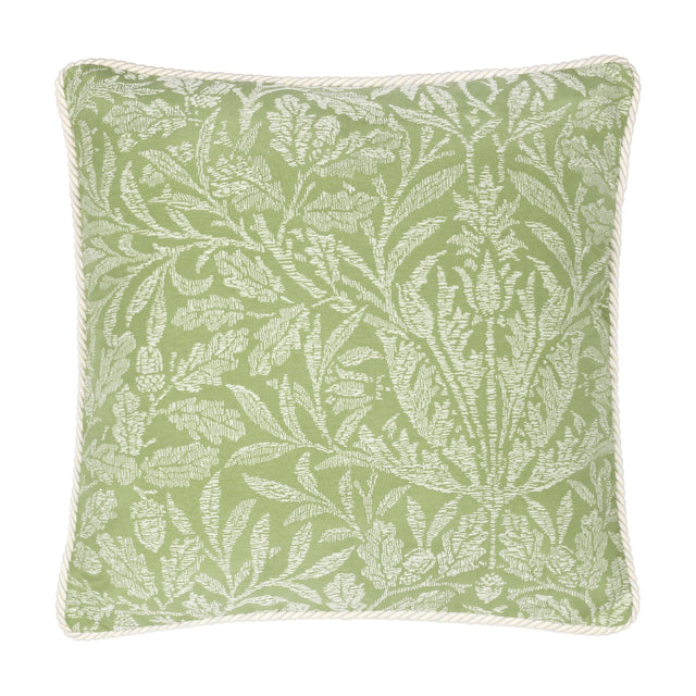 Square sage green cushion with a tonal jacquard acorn branch pattern in paler leaf tones, finished with cream cord piping, shown on a plain white background.