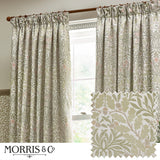 Pencil pleat curtains in Acorn jacquard chenille, stone and sage colourway with woven oak leaf and acorn pattern, shown pencil-pleated on a wooden pole beside a window, with fabric swatch inset.