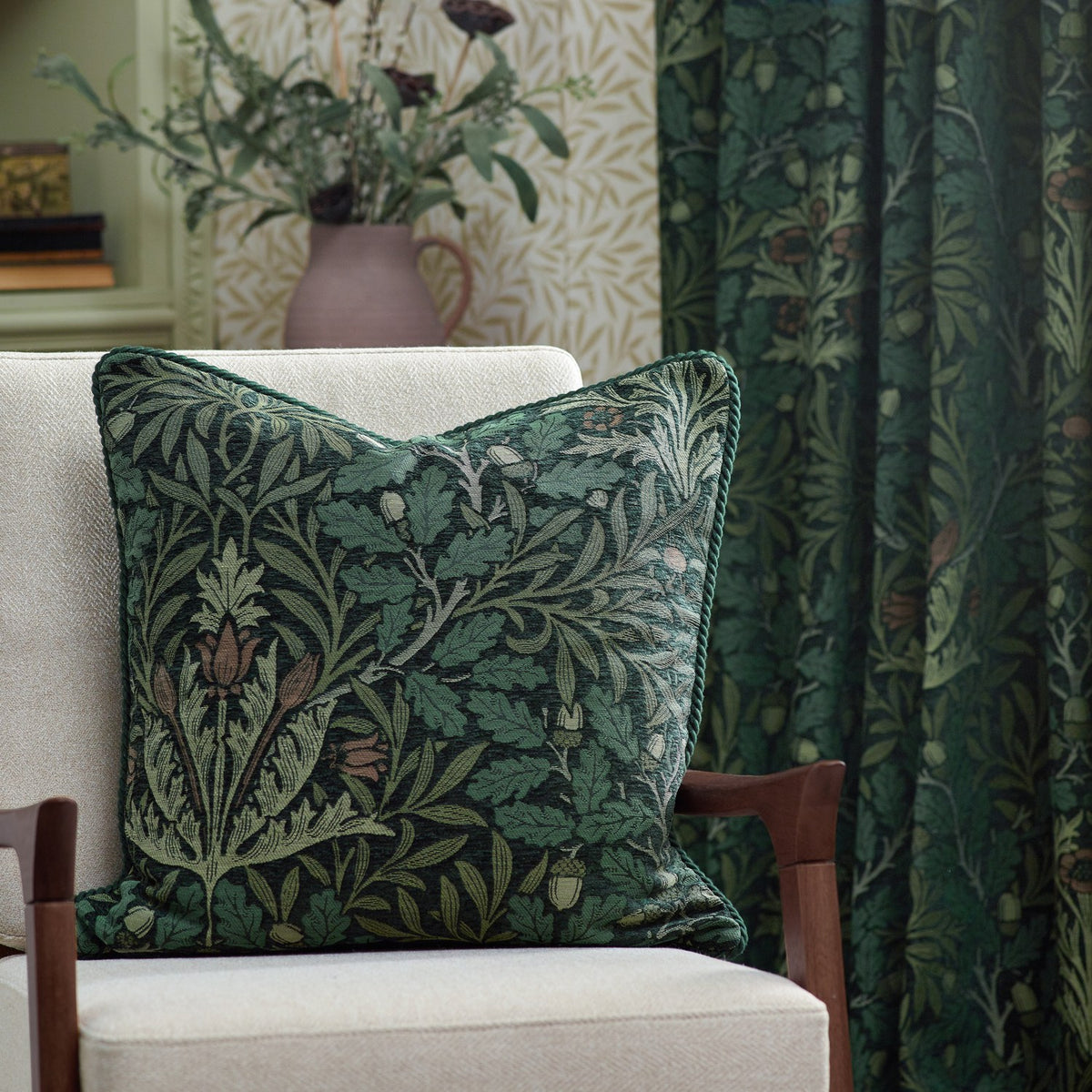 Acorn Multi Chenille Pencil Pleat Curtains in Thyme/Forest, shown as matching cushion and curtain fabric with green jacquard oak leaf and acorn pattern in a living room setting.