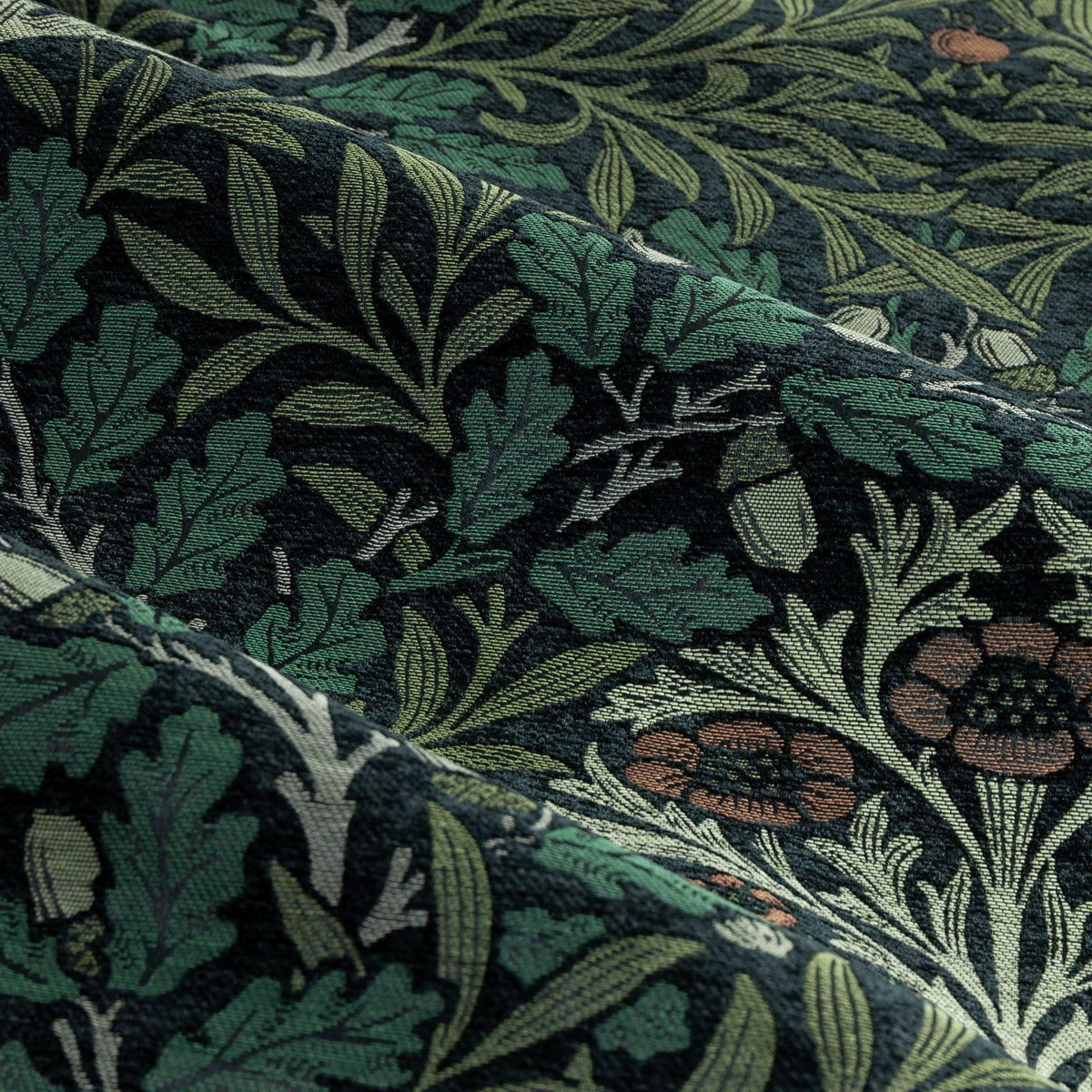 Close-up of Acorn Multi Chenille pencil pleat curtain fabric in Thyme/Forest, showing jacquard-woven oak leaves and acorns in green, sage and terracotta tones.
