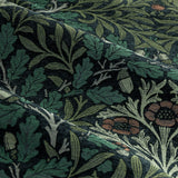 Close-up of Acorn Multi Chenille pencil pleat curtain fabric in Thyme/Forest, showing jacquard-woven oak leaves and acorns in green, sage and terracotta tones.