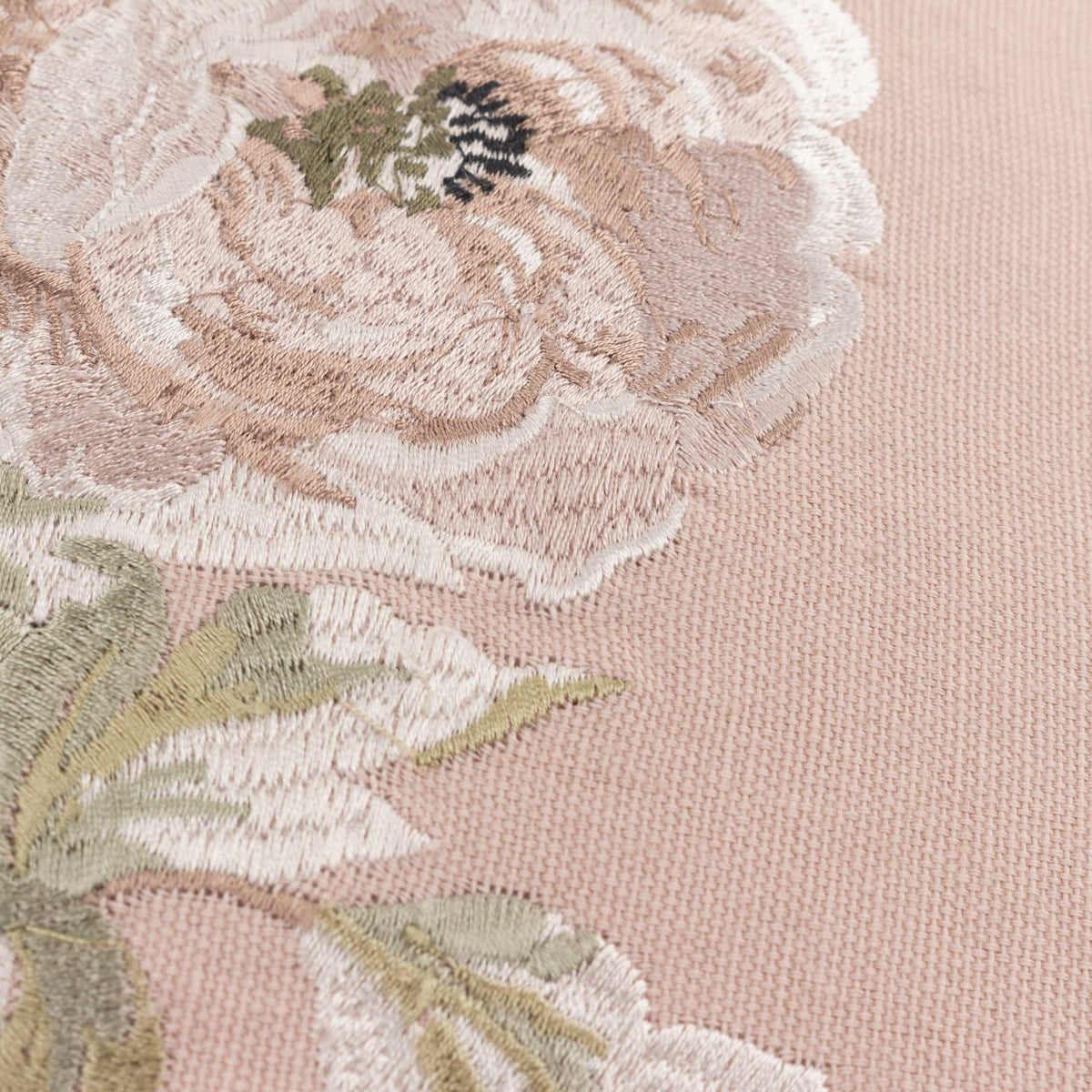 Close-up of the Adele Floral Cotton Cushion in Rose, showing embroidered blooms and trailing leaves in cream, taupe and sage thread on a rose-pink cotton ground.