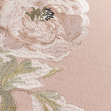 Close-up of the Adele Floral Cotton Cushion in Rose, showing embroidered blooms and trailing leaves in cream, taupe and sage thread on a rose-pink cotton ground.
