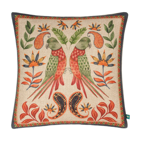 Akamba Animal Linen Cushion in multicolour, featuring two mirrored parrots in red and green with jungle florals and paisley motifs on a natural ground, bordered edge, shown on a white background.