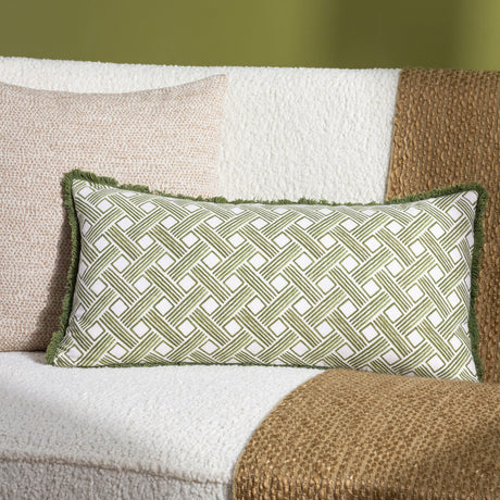Alexa Reversible Cotton Cushion in olive green basket weave print, rectangular bolster shape with fringed edge, styled on a cream boucle sofa with a jute throw.