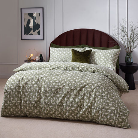 Alexa Cotton Abstract Duvet Cover Set in Olive, geometric basket weave print in olive green on cream, styled with matching pillowcases and a velvet cushion on a bedroom bed.