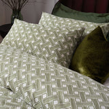 Alexa Cotton Abstract Duvet Cover Set in Olive, featuring a geometric basket weave print on cream cotton-rich fabric, styled with matching pillowcases and a solid olive velvet cushion.