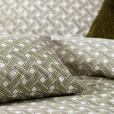 Alexa Cotton Abstract Duvet Cover Set in Olive, close-up of pillows and bedding with an interlocking geometric basket weave print in olive green on cream cotton-rich fabric.
