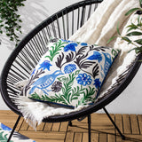 Aljento Abstract Polyester Cushion in blue, square with hand-painted bird and floral print in blue, green and black on white, shown on a black woven outdoor chair.