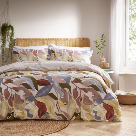 Amarosa Reversible Abstract Duvet Cover Set in Plaster with matching pillowcases, featuring a hand-painted leaf and floral print in clay, dusty pink, olive, gold and slate blue tones.