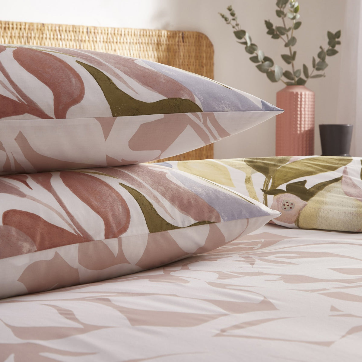 Amarosa Reversible Abstract Duvet Cover Set in Plaster, with matching pillowcases featuring a hand-painted floral print in terracotta, olive, slate blue and dusty pink on white cotton-blend fabric.