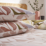 Amarosa Reversible Abstract Duvet Cover Set in Plaster, with matching pillowcases featuring a hand-painted floral print in terracotta, olive, slate blue and dusty pink on white cotton-blend fabric.