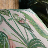 Close-up of the Amazonia Reversible Jungle Duvet Cover in Jade, showing a printed parrot, dragonfly, and palm leaf design in green and pink tones on polycotton fabric.