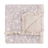 Amelia Ditsy Cotton Bedspread in blush, folded to show quilted floral print and reverse side with cream ruffled trim, on a white background.
