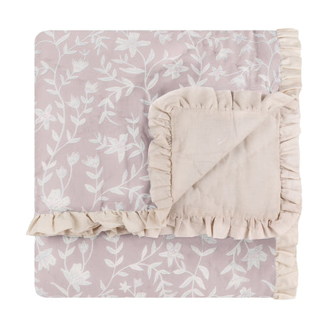 Amelia Ditsy Cotton Bedspread in blush, folded to show quilted floral print and reverse side with cream ruffled trim, on a white background.