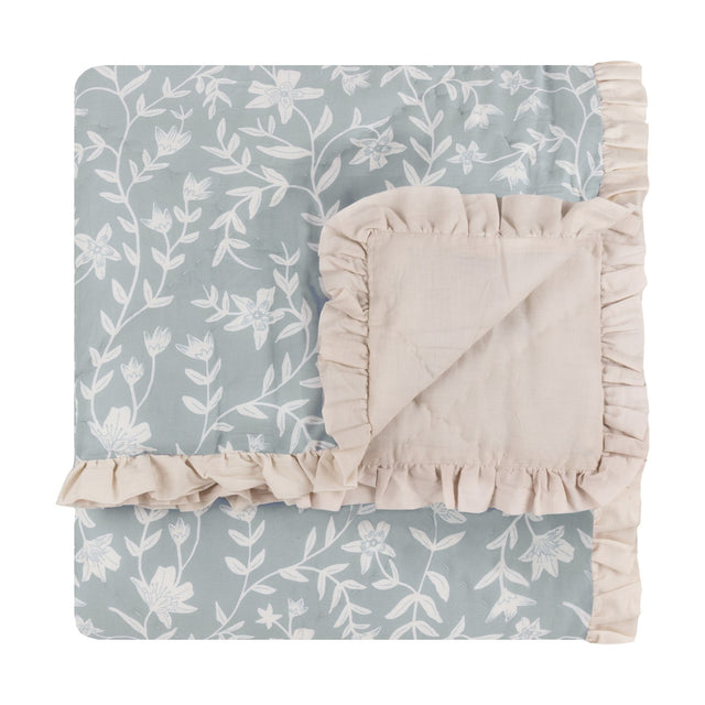 Amelia Ditsy Cotton Bedspread in seafoam, diamond-quilted cotton throw with small floral print and ruffled beige trim, folded on a white background.