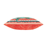 Side view of the Anemone Reversible Polyester Cushion showing coral-red floral fabric on one edge and a teal scalloped border with green leaf print on the other, set against a plain white background.