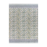 Annabelle reversible cotton bedspread in blue, showing a scrolling floral pattern in blue-green and teal tones with a coordinating striped border, on a plain white background.