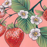 Anemone Reversible Polyester Cushion in a strawberry print design, showing red strawberries, white five-petalled flowers with yellow centres, and green leaves on a coral-pink fabric ground.