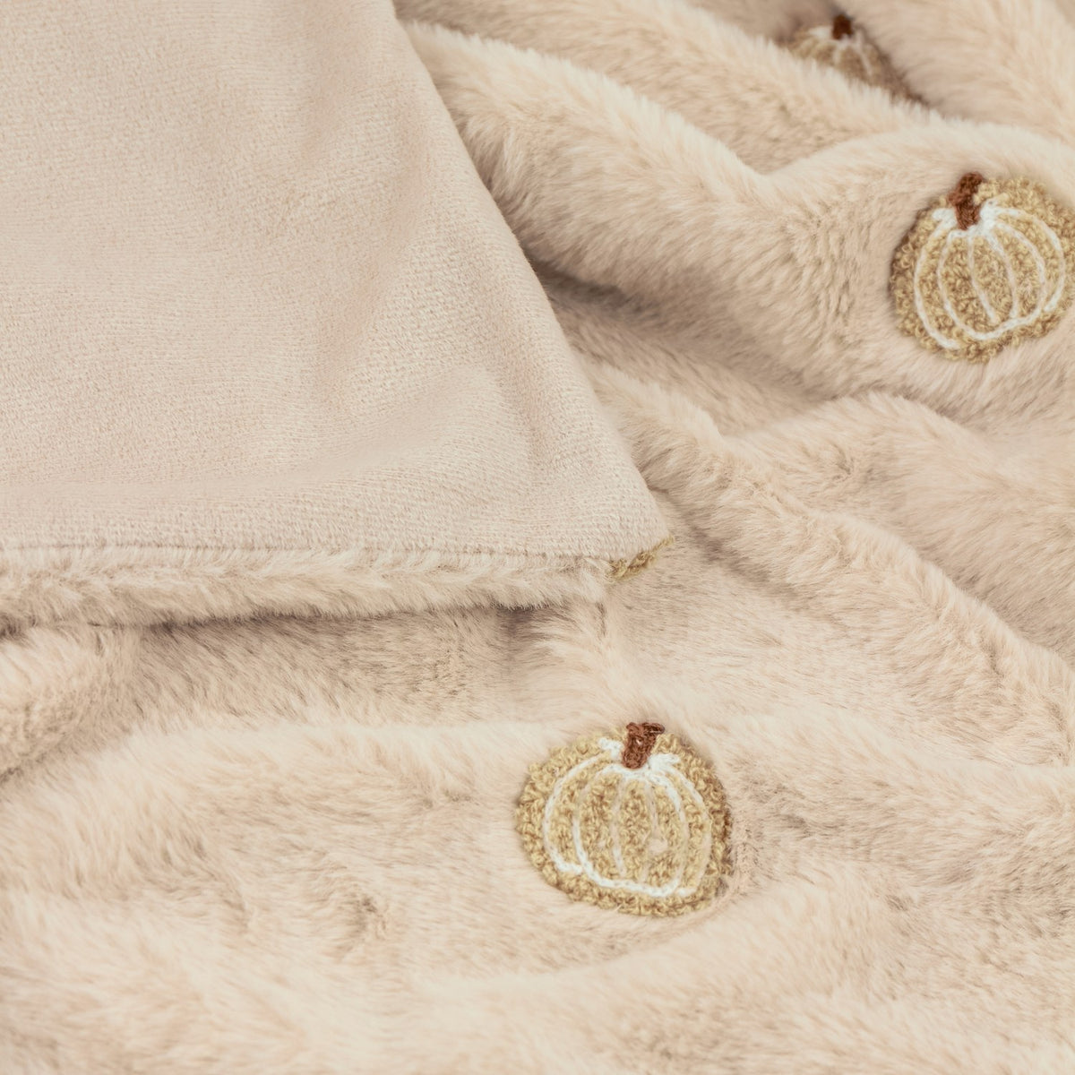 Autumn Pumpkins Velvet Faux Fur Throw in natural beige, close-up of plush pile with embroidered pumpkin motifs and soft velvet reverse edge.
