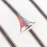 Abersoch Regatta cotton cushion in ecru, close-up of an embroidered sailboat in red, cream and pale blue against navy and sandy yarn-dyed vertical stripes.