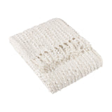Arvo Plain Cotton Throw in natural cream, folded to show textured vertical boucle rows and knotted fringe edge, on a plain white background.