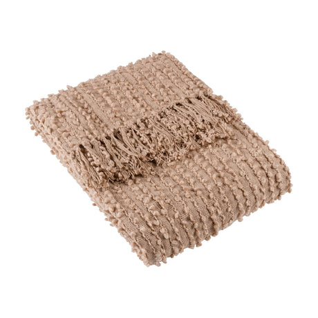 Arvo Plain Cotton Throw in Plaster, folded to show its boucle-textured woven surface with fringed edge, in a warm beige cotton-polyester blend on a plain white background.