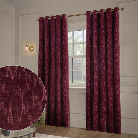 Aurelio Chenille Jacquard Fully Lined Eyelet Curtains in burgundy, hung on a gold rod either side of a window, with a fabric texture inset showing the mottled woven pattern.