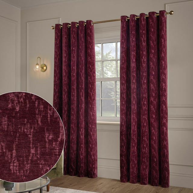 Aurelio Chenille Jacquard Fully Lined Eyelet Curtains in burgundy, hung on a gold rod either side of a window, with a fabric texture inset showing the mottled woven pattern.